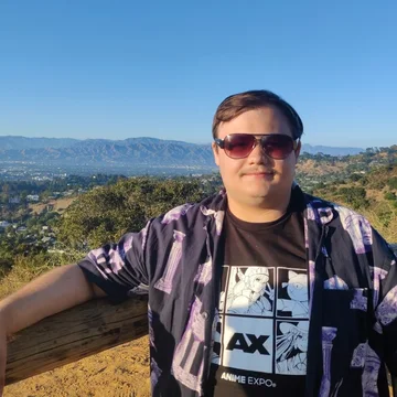 Noah outdoors at a scenic overlook